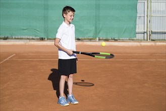 Long shot kid playing tennis