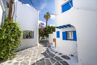 White Cycladic houses with colourful shutters and doors