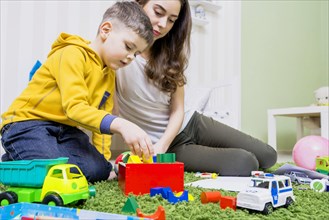 Boy playing toys with woman