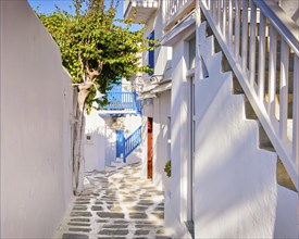Traditional narrow streets and beautiful alleyways of Greek island towns. Whitewashed houses