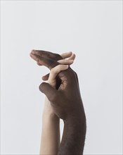 Black white hands holding sideways