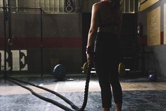 Woman holding rope gym