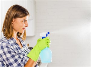 Young woman cleaning house