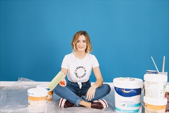 Blonde woman with paint materials