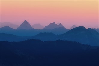 Hilly landscape with mountains Kleiner and Grosser Mythen after sunset