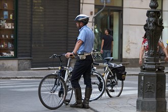 Policeman next to bicycle