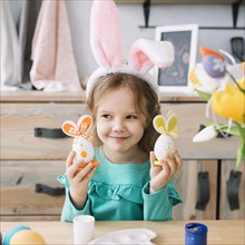 Cute girl bunny ears holding easter eggs