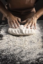 Chef kneading dough table