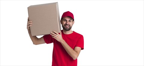 Courier man holding his shoulder big delivery box