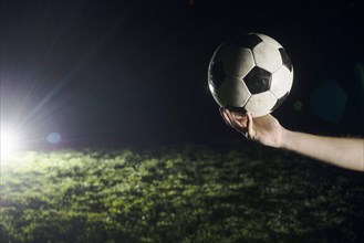 Crop hand with soccer ball