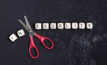 Equality inequality concept with scissors