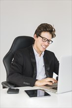 Happy businessman working laptop office