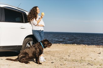 Young woman with her dog beach