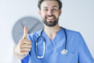 Blurred doctor showing thumb up gesture