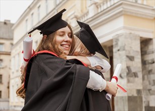 Girls hugging graduation