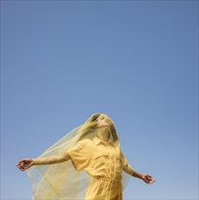 Portrait joyful woman with yellow cloth nature