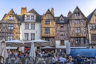 Medieval buildings and crowded restaurants in the central square Place Plumereau