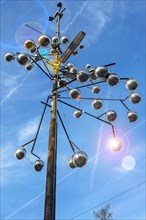Pole of a street light as a work of art with disco balls