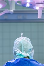 Operating doctor in sterile surgical clothing during an operation in hospital