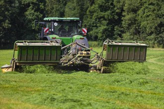 Grass mowing in a small field near Waldheim with a John Deere tractor