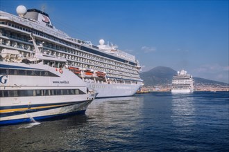 Cruise ships at Statione Marittima in port with Mount Vesuvius