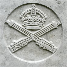 Machine Gun Corps regimental badge on headstone at Cemetery of the Commonwealth War Graves Commission for First World War One British soldiers