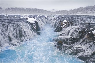 Aerial view over Bruarfoss waterfall in winter