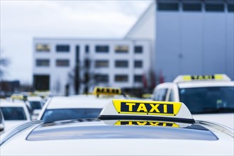 Many taxis stand and wait at a holding area at Duesseldorf airport