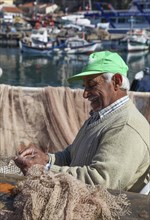 Fishermen mending nets in the Old Port of Antalya