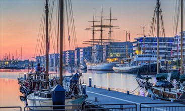 Historic icebreaker Whale and sail training ship Germany in the New Harbour at dusk