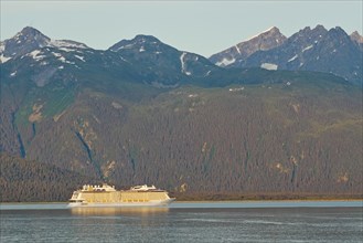 Cruise ship in front of high mountains