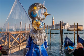 Carnival mask on the waterfront with San Giorgio Island at the time of Carnival