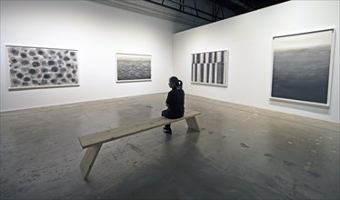 Korean woman looking at a Korean artwork