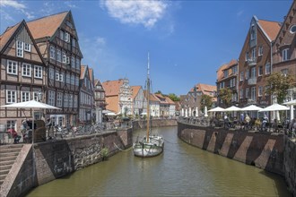 Historic merchant and warehouse houses at the Hanseatic harbour with the sailing ship Willi