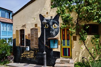 Hostel with graffiti of a black cat on the facade