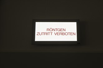 Sign above a door in a hospital with the inscription Roentgen Zutritt Verbot