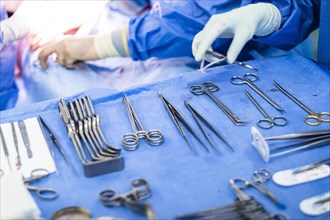 Operating table with surgical cutlery during an operation in a hospital