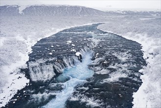 Aerial view over Bruarfoss waterfall in winter