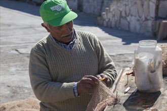 Fishermen mending nets in the Old Port of Antalya