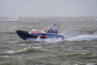 Rescue lifeboat KNRM Jan van Engelenburg from Hansweert patrolling in stormy weather in winter along the North Sea coast of Zeeland