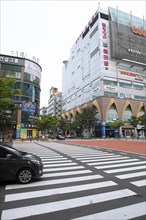 Street with zebra crossing between high-rise buildings