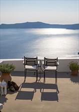 Sea and caldera view from terrace with chairs