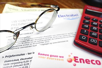 Red calculator and Flemish invoices of Eneco and Electrabel