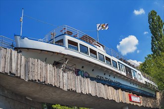 Converted ship on railway bridge as restaurant and bar