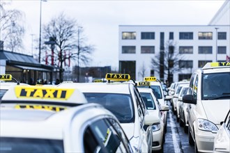 Many taxis stand and wait at a holding area at Duesseldorf airport