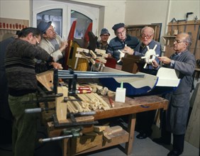 Group of pensioners produces toys for children. 80s