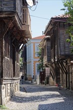 Half-timbered houses with typical roof overhang on the cobbled street in the old town. Sozopol