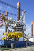 Offshore jack-up installation vessel Vole Au Vent with crane for assembling wind turbines moored at REBO heavy load terminal in Ostend port
