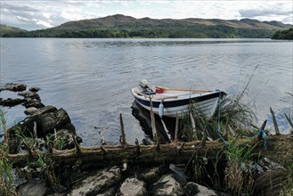 A motor boat tied up on the shores of Lough Gill at evening time. Sligo