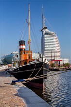 Historic ship in the New Harbour with the Atlantic Sail City Hotel